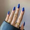 Chic blue almond press-on nails with gold eyeglass and signet rings on a black leather sleeve - Deep Blue (JP2137)