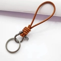 Brown braided leather keychain with dark metal horseshoe D-ring and split ring - Natural Leather Silver Horseshoe Buckle