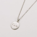Detailed view of silver stainless steel round pendant with engraved Faith lettering - Steel Color Faith Engraved