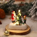 Close-up of glowing resin Santa miniature on wood base with snowy background - Santa and Boy Style