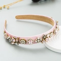 Pink satin headband with vintage gold bees, faux pearls and crystals on a white tray - Pink