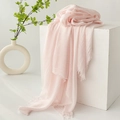 Pink cotton linen scarf with soft fringe edges displayed on a white minimalist pedestal - Light Pink