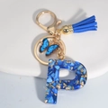 Royal blue resin letter P keychain with tassel, butterfly charm and gold foil accents - Letter P