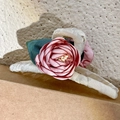 White hair claw clip featuring pink fabric rose and green leaves on textured background - Pink Petal (2302042)