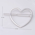 Detail view of a hollow silver metal heart hair clip with dimensions 4.5cm by 6.2cm - Silver Heart