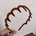 Detailed view of brown velvet headband texture with black inner plastic teeth - Wave Toothed Style / Brown