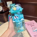 Close-up of teal Capybara water bottle with shark silicone sleeve and portable lanyard - Blue Shark