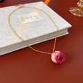 Detail of pink dried rose pendant on gold chain necklace over vintage book - Necklace / Purple