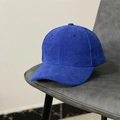 Detail of blue corduroy baseball cap texture resting on a grey leather seat surface - M (56-58cm) / Blue