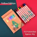 8-color Christmas wax crayon set featuring cartoon reindeer and festive tree illustrations - Christmas Crayons - Yellow Box (8 Colors)