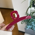 Detail of a large glossy rose pink hair claw clip made of resin with gold metal spring - Rose Pink