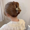 Detail of golden flower hair claw clip with rhinestones and dangling pearl on model - Peach Blossom Claw Clip