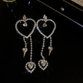 Macro detail of silver heart tassel earrings with sparkling rhinestones on black background - Silver Heart Tassel (925 Silver Pin)