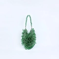 Detailed close-up of handmade green faceted crystal beads on a stylish evening handbag - Emerald Green