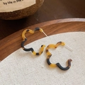 Close-up of leopard print resin C-shaped hoop earrings on a rustic linen backdrop - 12# Coffee