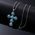 Silver stainless steel cross necklace featuring natural-textured turquoise stone insets - Round Turquoise Cross