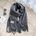Solid dark grey long scarf with fringe tassels and brand label on plush background - Deep Heather Grey