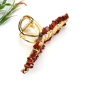 Detail view of gold alloy hair claw clip decorated with natural reddish crystal stones - Large B Style 11.5cm + Red Jasper