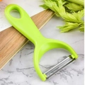 Green plastic vegetable peeler with stainless steel blade on marble countertop - Fruit Peeler / Green