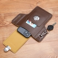 Brown leather waist bag with phone compartment, card slot, and key hook on wood background - Brown Standard Phone Bag