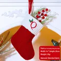 Red knit Christmas stocking with embroidered letter Q and white cuff hanging on fireplace - Letter Q / Red