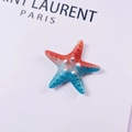 Macro detail of gradient red and blue starfish charm with pearl-like texture - Small Starfish / Red Blue Gradient