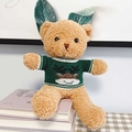 Brown teddy bear in green reindeer sweater and leaf bunny ears on stacked books - Brown Bear - Green Sweater Reindeer / 30cm