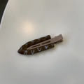 Macro detail of leaf-shaped hair clip in dark brown with glossy wavy texture finish - Dark Brown / Coffee Clip