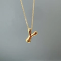 Close-up of polished gold-finished letter Y pendant on a delicate chain necklace - Letter Y Single Pendant