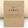 Detailed view of silver interlocking circles Karma necklace on a brown kraft paper card - Three Rings Karma Card / Silver