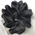 Oversized black satin hair scrunchie with glossy finish and elegant soft pleated texture - Black