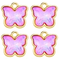 Detailed view of four pink crystal butterfly pendants with gold metal borders for DIY jewelry - Pink Purple