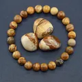Detailed view of natural picture jasper stone beads with unique earthy landscape patterns - Jasper