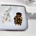 Mini acetate hair claw clip with tortoise shell pattern reflected on a mirror - Amber Pattern