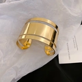 Close-up of golden mirror finish cuff bracelet featuring parallel hollowed-out lines - Gold Mirror Hollow Line Style