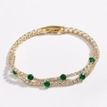 Close-up of double-row gold tennis bracelet with white cubic zirconia and green gemstones - Green Round Zircon Gold