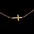 Polished golden stainless steel cross pendant necklace on a sleek black background - Gold Cross