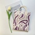 Top-down view of knitted mini tote with purple wave patterns and cream rubber handles - Purple Wave Pattern