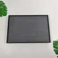 Top view of jewelry tray showing rows of grey velvet slots for rings and earrings - Black Brushed Leather + Grey Suede