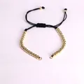 Adjustable black woven bracelet with gold beads and sliding knot closure in flat lay view - Black-24 Beads