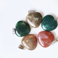 Green and reddish-brown heart-shaped stone pendants with polished finish and metal bails - India Agate