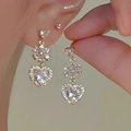 Close-up of golden heart and snowflake earrings with sparkling zircon gemstones - Gold Snowflake Heart Rhinestone Earrings (1330 Earrings)