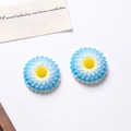 Detailed macro shot of dual-tone blue and white resin daisy craft accessories - Blue