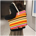 Detailed back view of a colorful striped canvas tote bag with thick hemp rope straps - Orange Stripes