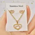 Detail of a gold heart jewelry set with necklace and earrings held on a display card - Classic Heart / Gold
