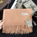Elegant apricot solid imitation cashmere scarf with fringes shown in a cozy flat lay scene - 200x68cm / Orange Pink