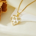 Detail of a white heart pendant with gold accents and sparkling crystals on a fine chain - Gold White Heart Necklace (T021)