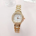 Detail shot of the golden rhinestone-set dial and metal strap of this luxury quartz watch - Rose Gold