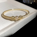 Close-up of 18K gold plated bangle featuring a sparkling zircon clover ring design - 3# Golden Hollow Clover Style (3#)