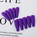Macro detail of dark purple matte coffin press on nails displayed on stylish magazine - Violet